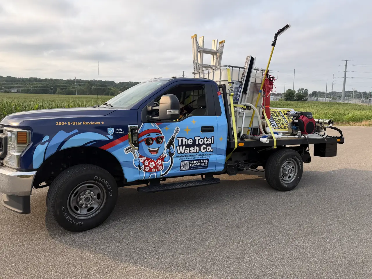 Side profile of The Total Wash Co.'s wrapped Ford F-250 with the flatbed wash rig — Madison, WI