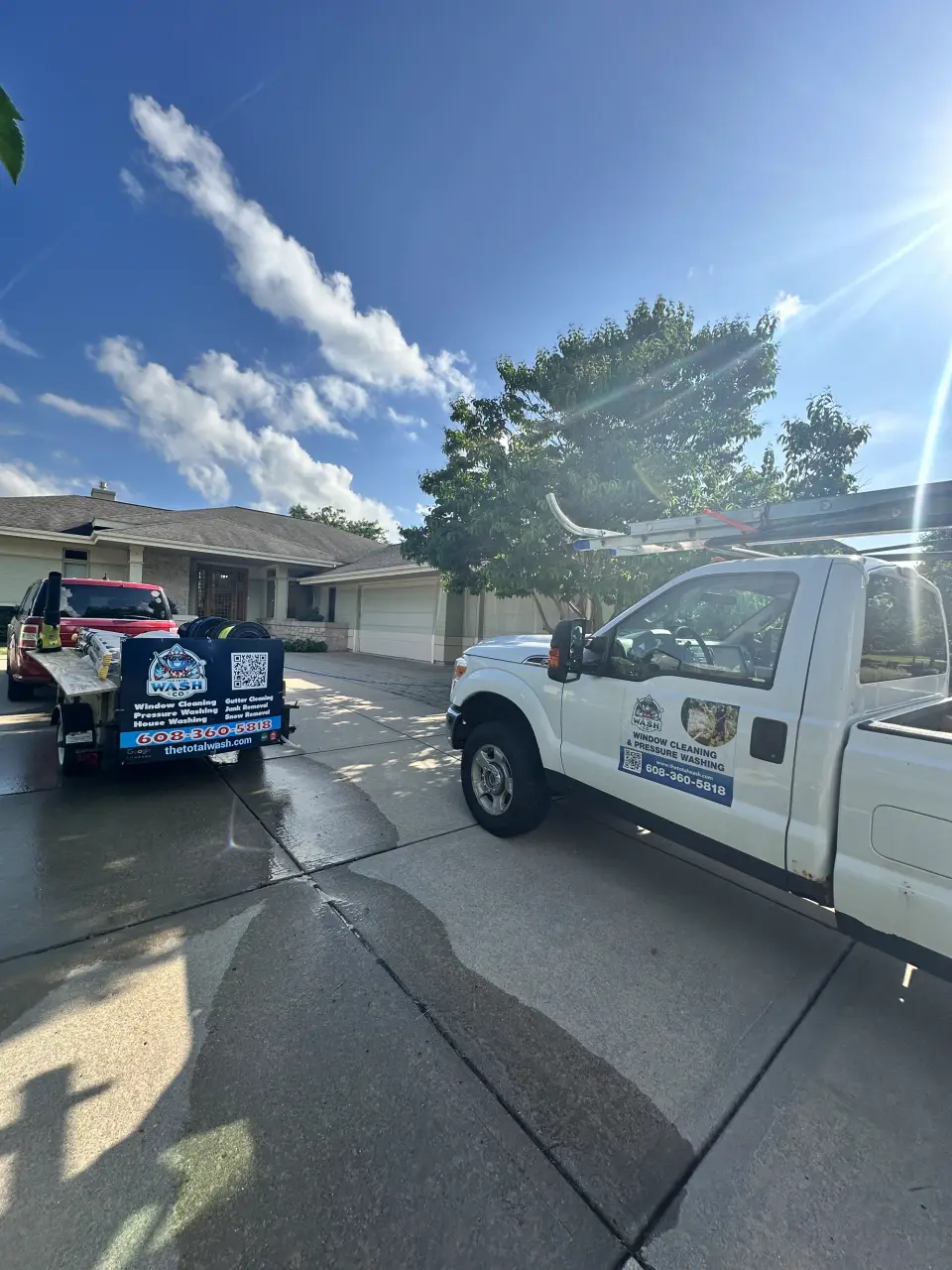 A Total Wash Co. truck parked in the driveway of a Verona, WI home on a sunny day